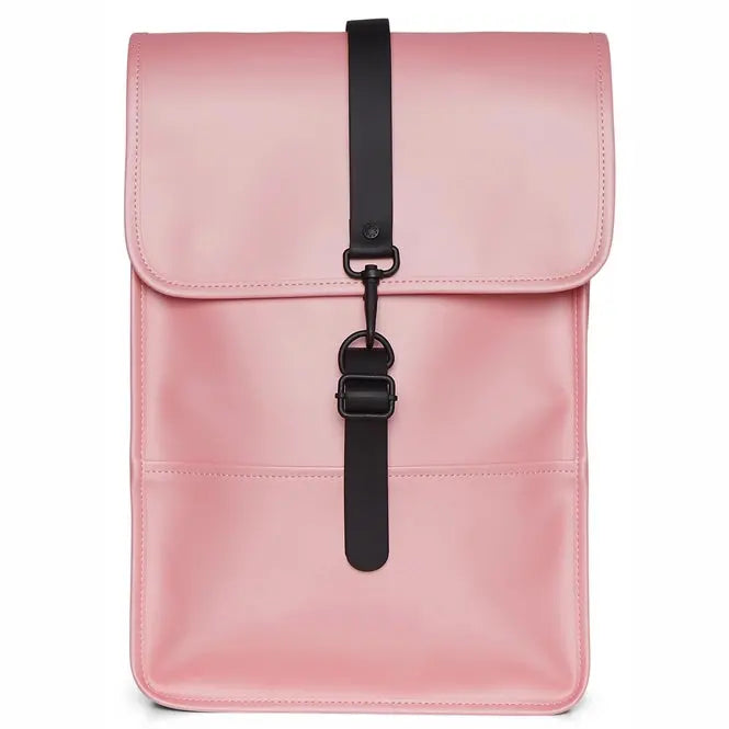 Sac à dos rose clair, Backpack Mini de Rains, avec une sangle de fermeture noire et des détails métalliques.