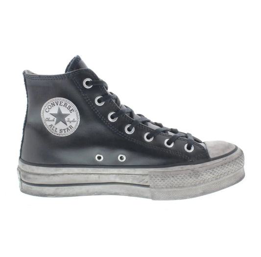 Baskets montantes en cuir noir de Converse, avec semelle intermédiaire vieillie à plateforme.