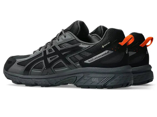 Chaussure de trail noire et grise Asics Gel-Venture 6, avec détails orange à l'arrière.