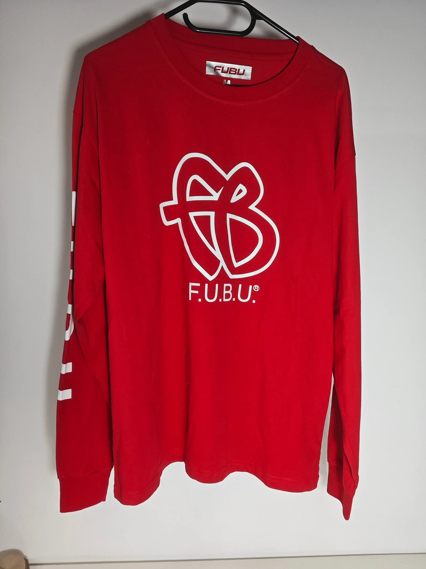T-shirt rouge à manches longues de Fubu, avec un grand logo blanc sur le devant.