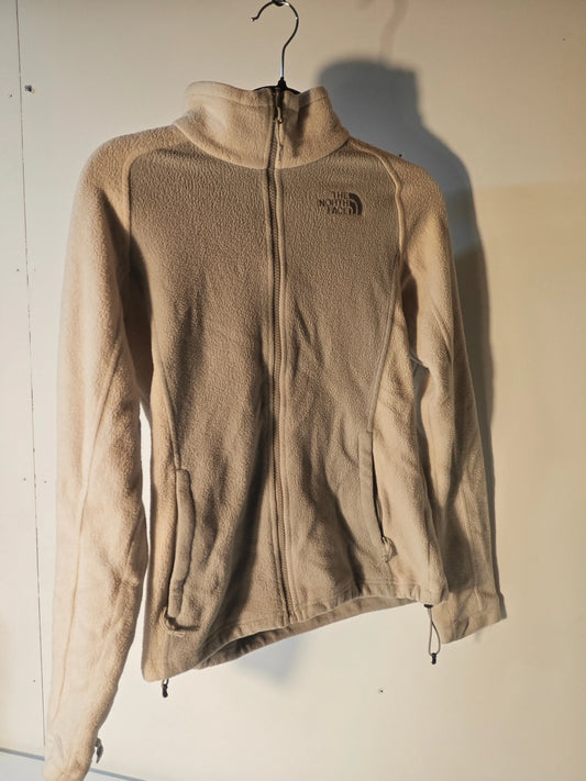 Polaire beige en polaire, de The North Face, avec fermeture éclair et poches zippées.