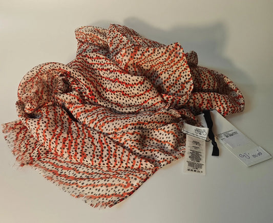 Foulard orange zébré de Le temps des cerises, avec motif à pois noirs et franges décoratives.
