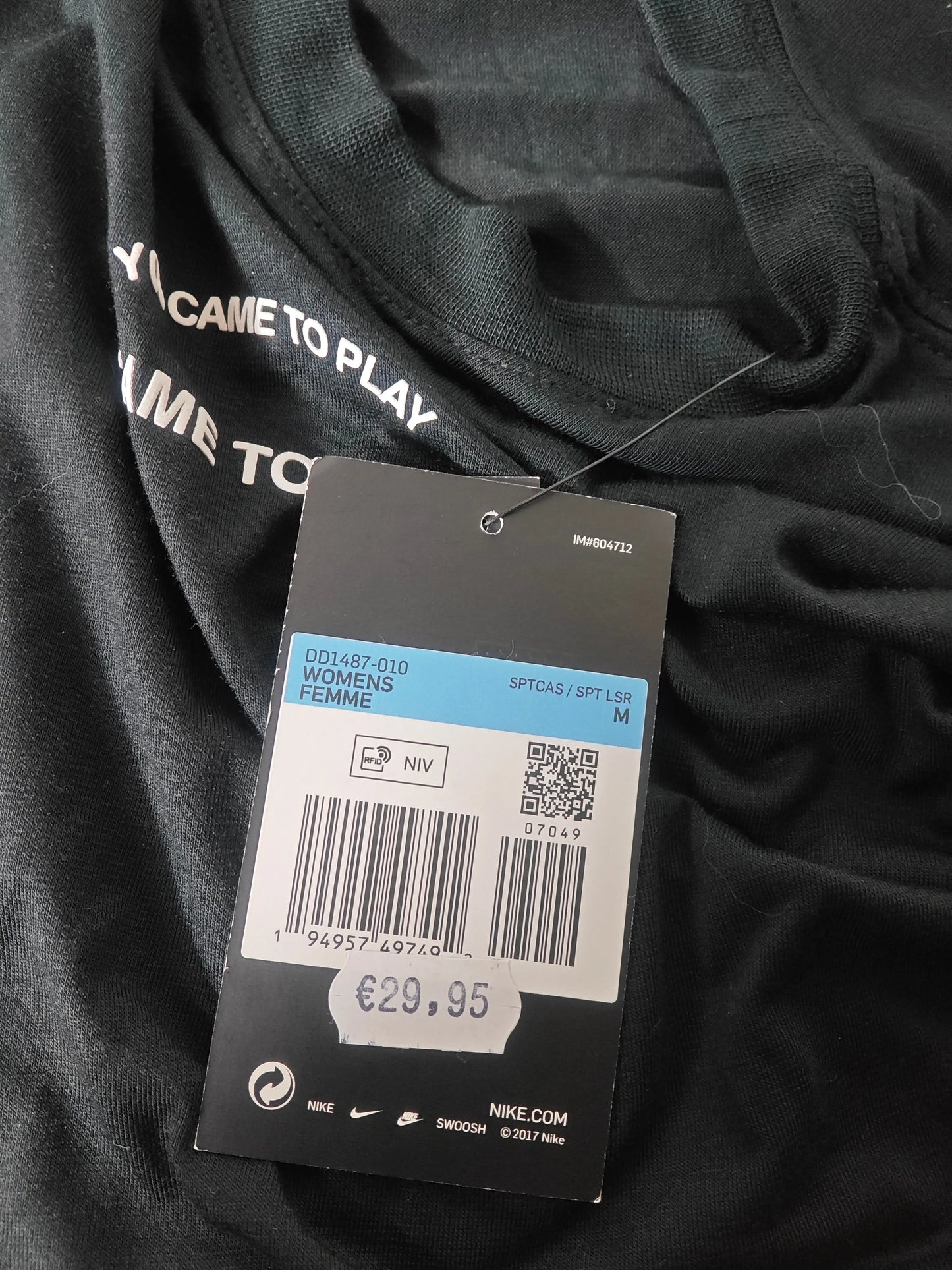 T-shirt court noir pour femme par Nike, avec un message blanc "I Came To Play" et une étiquette.
