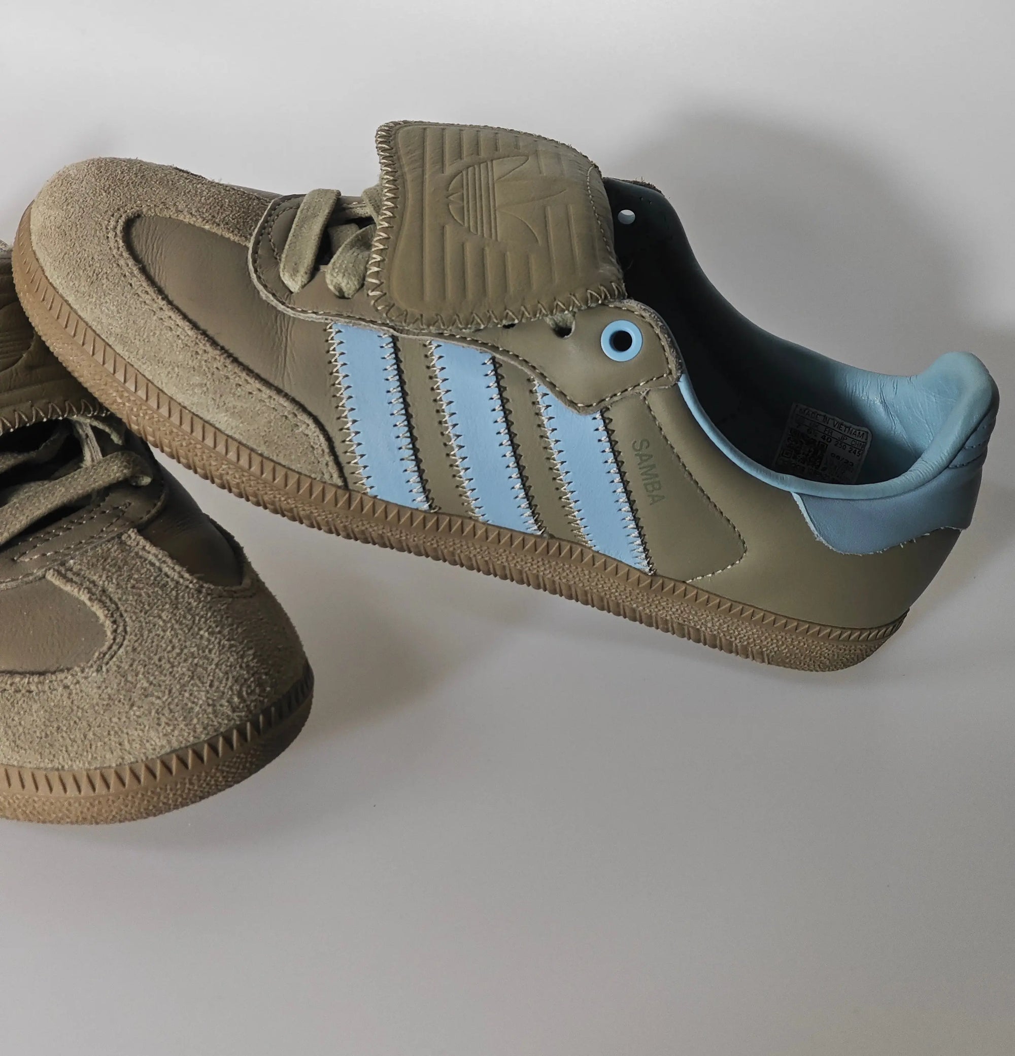 Baskets Samba en daim taupe et cuir, par Adidas, avec les trois bandes bleu clair.