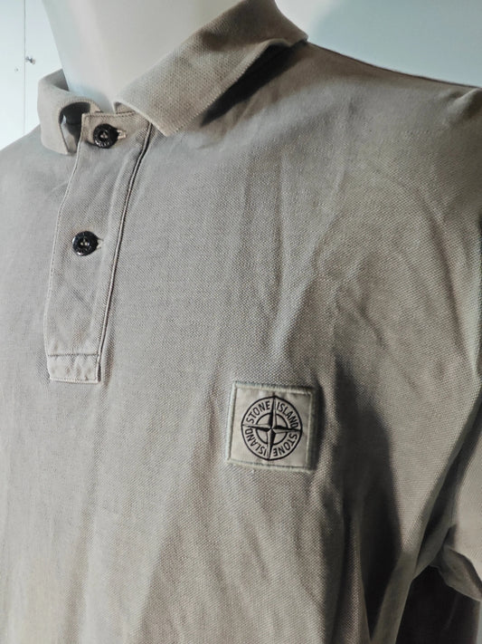 Polo gris de Stone Island avec deux boutons et patch logo sur la poitrine.