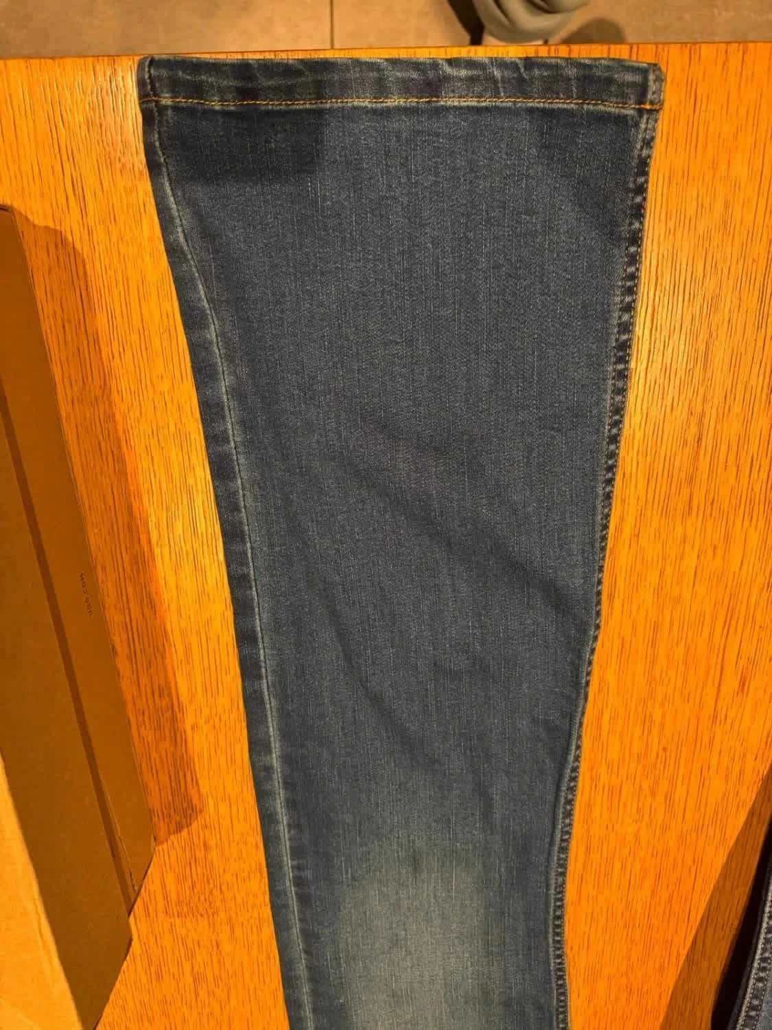Jean bleu Lois, sur une table en bois.
