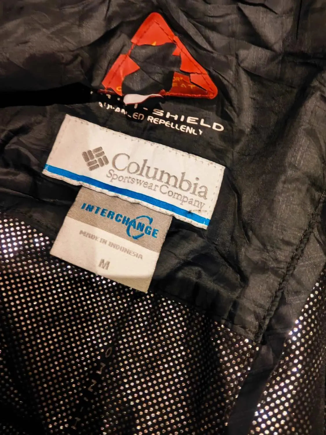 Veste Columbia Interchange Omni-Heat noire de Columbia, avec doublure argentée à motif à pois et étiquette de taille M.